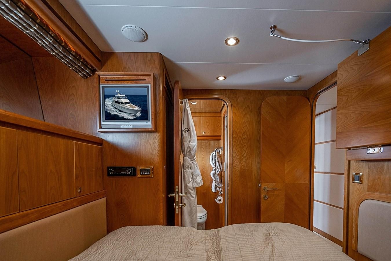 a bedroom with a bed and a closet aboard ROXY MARIA Yacht for Sale