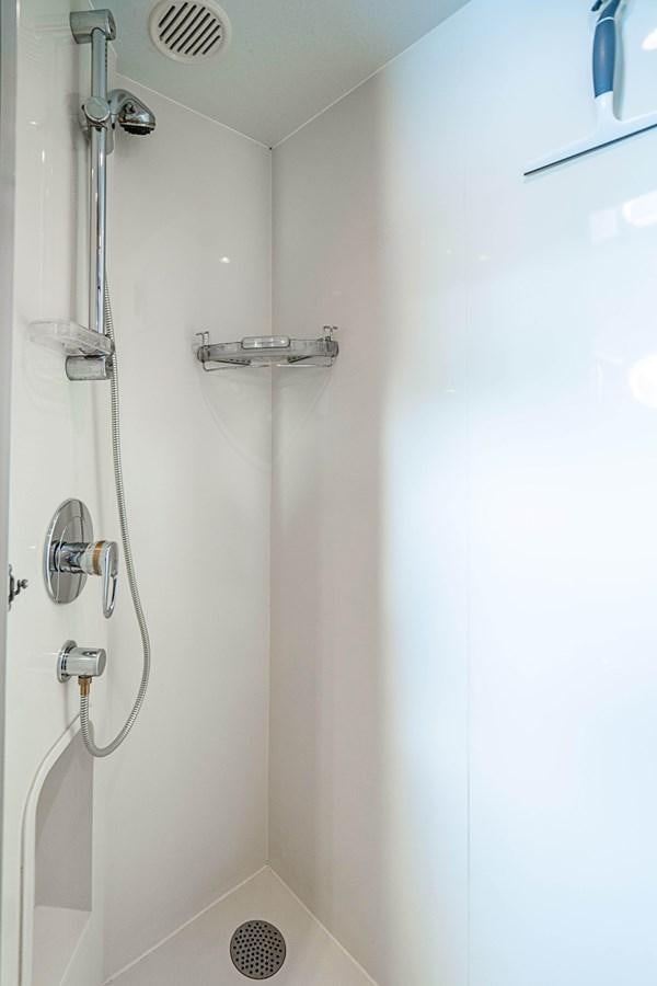 a shower with a white wall aboard ROXY MARIA Yacht for Sale