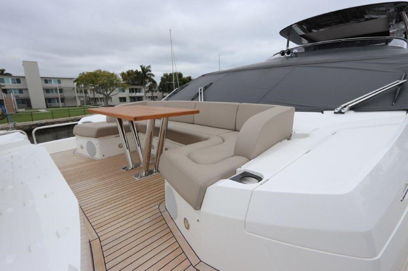 a rooftop deck with a table and chairs on it aboard AQUA VISTA Yacht for Sale