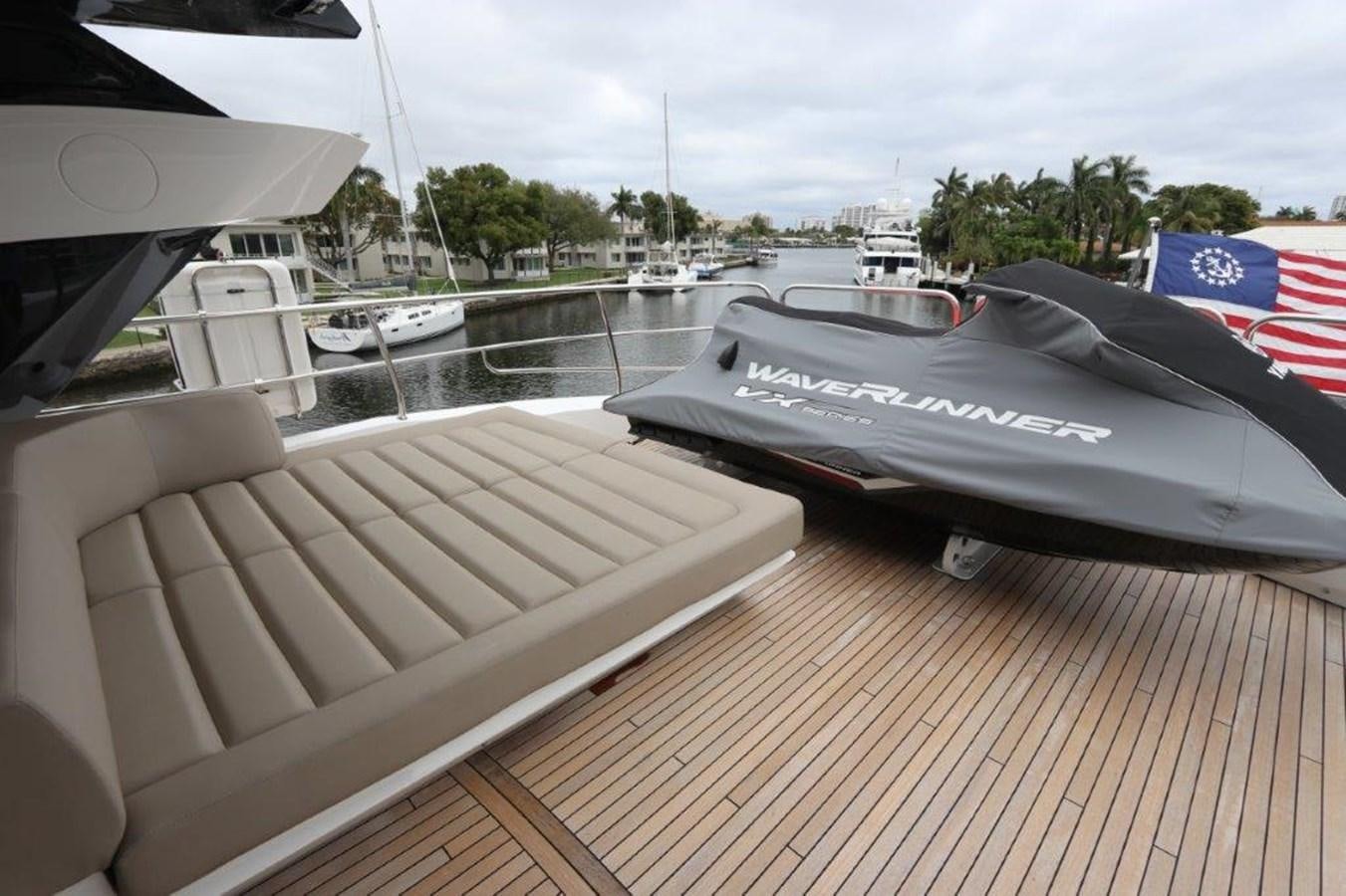 a deck with a boat and a flag on it aboard AQUA VISTA Yacht for Sale