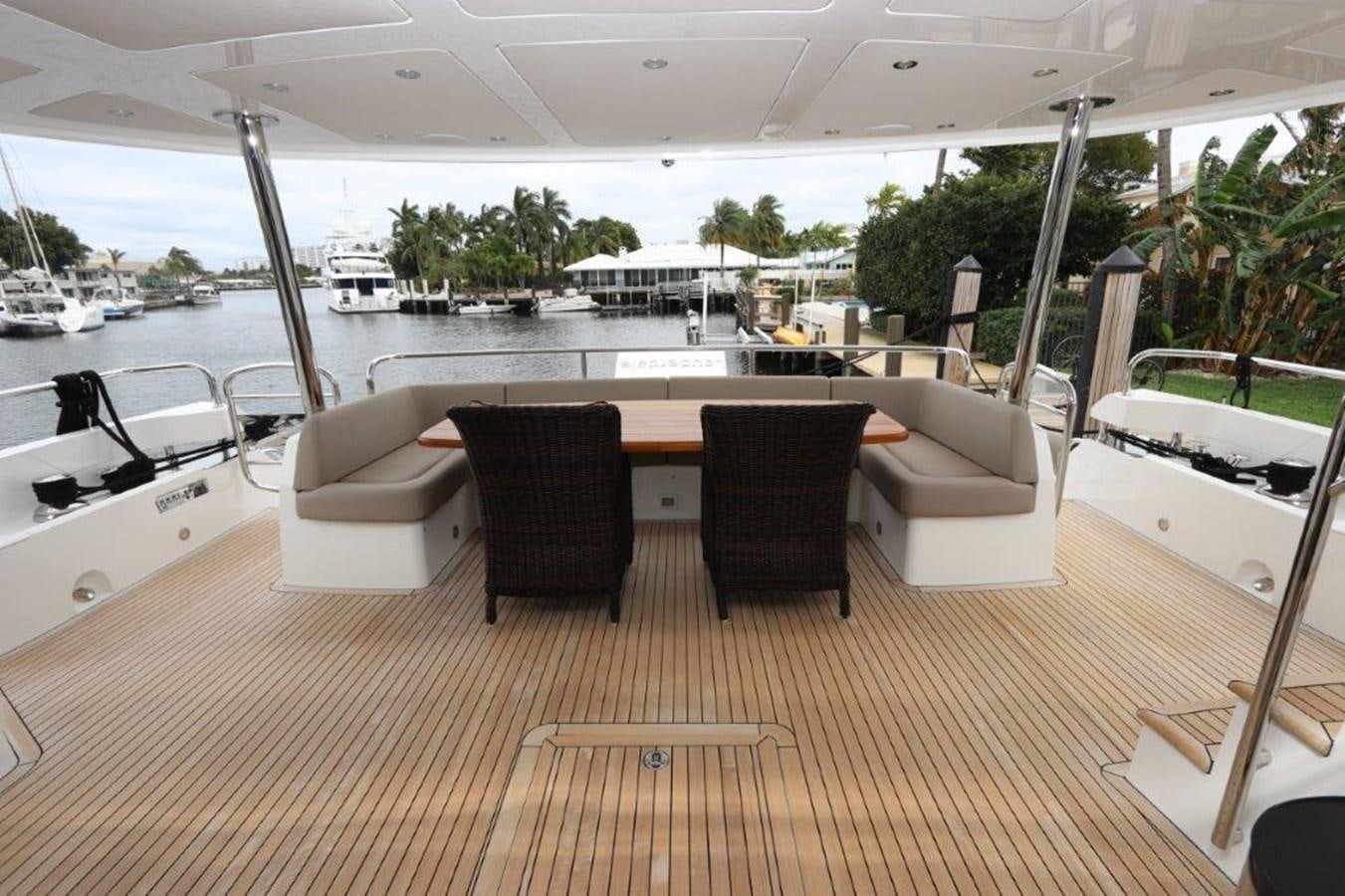 a room with a table chairs and a boat in the water aboard AQUA VISTA Yacht for Sale