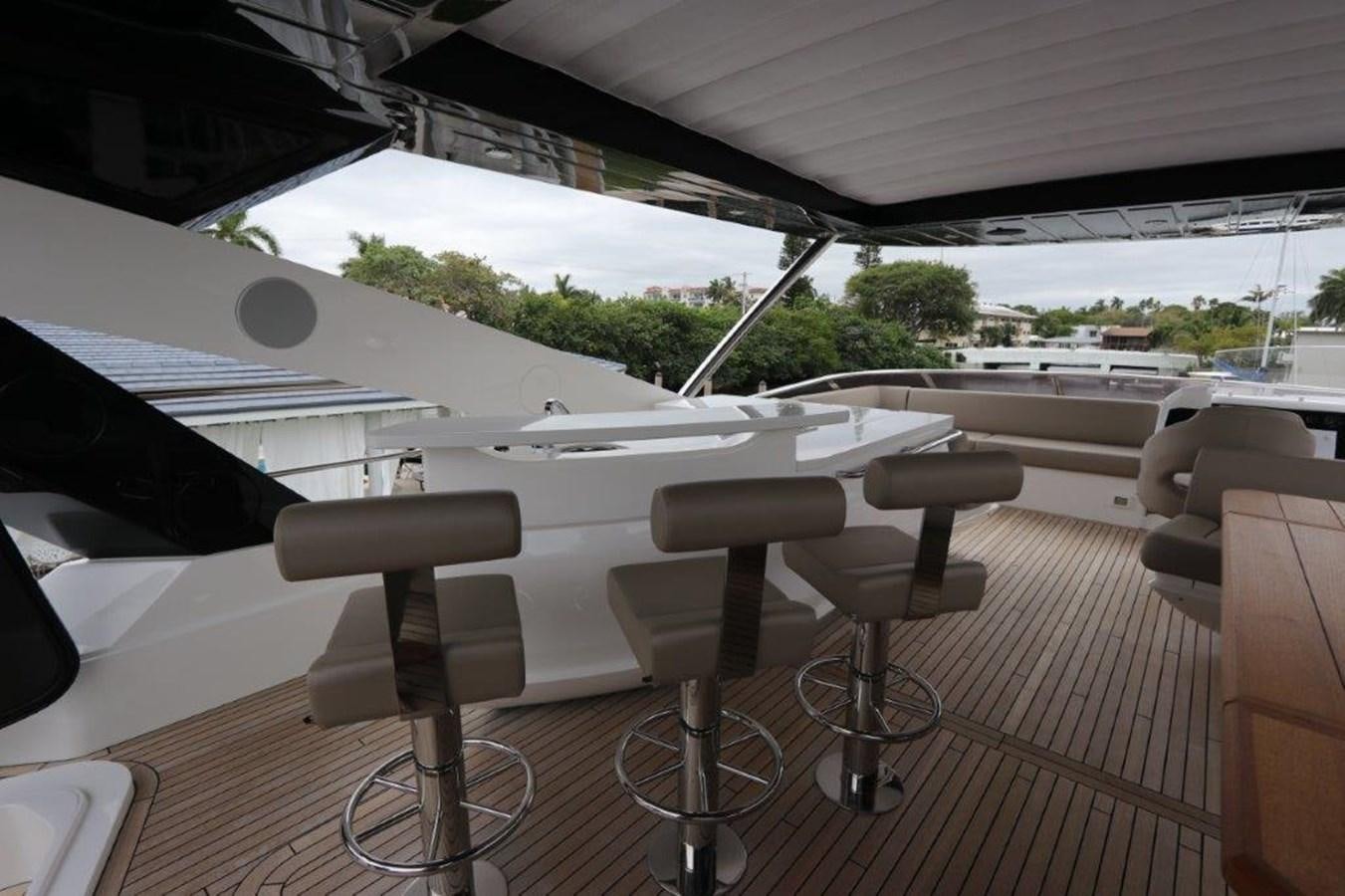 a white table with chairs and a white umbrella on it aboard AQUA VISTA Yacht for Sale