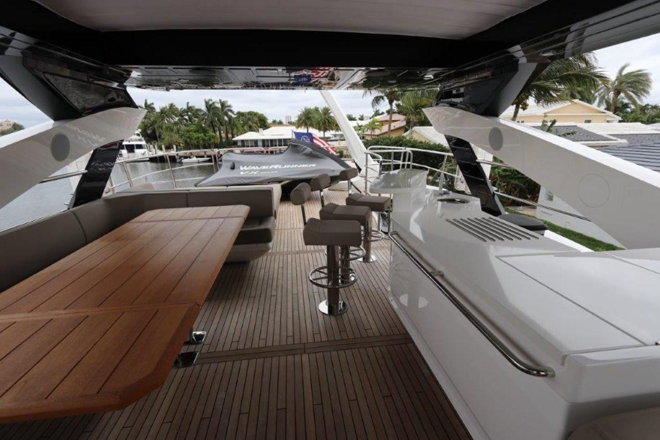 a deck with a table and chairs aboard AQUA VISTA Yacht for Sale