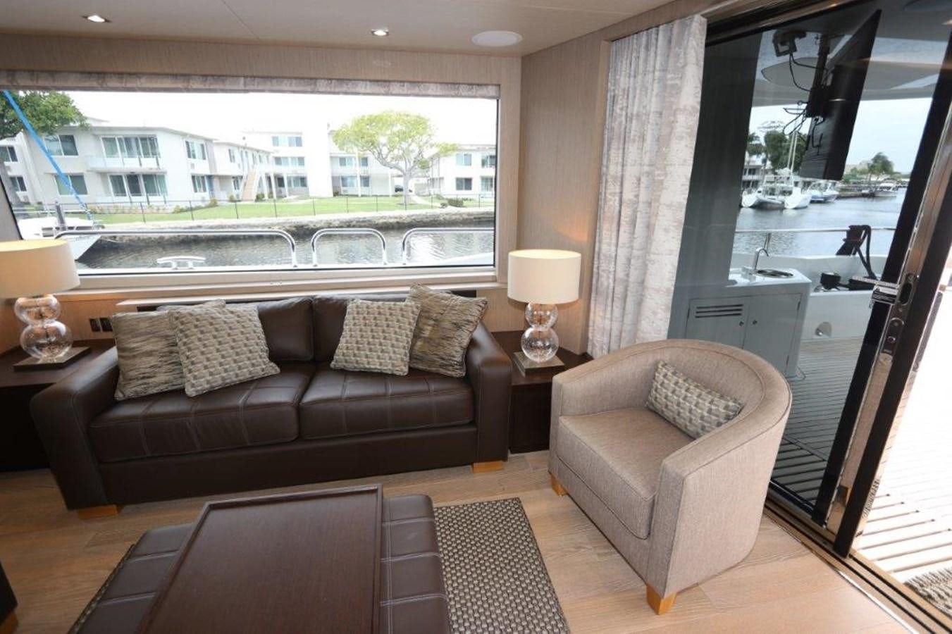 a living room with a large window aboard AQUA VISTA Yacht for Sale