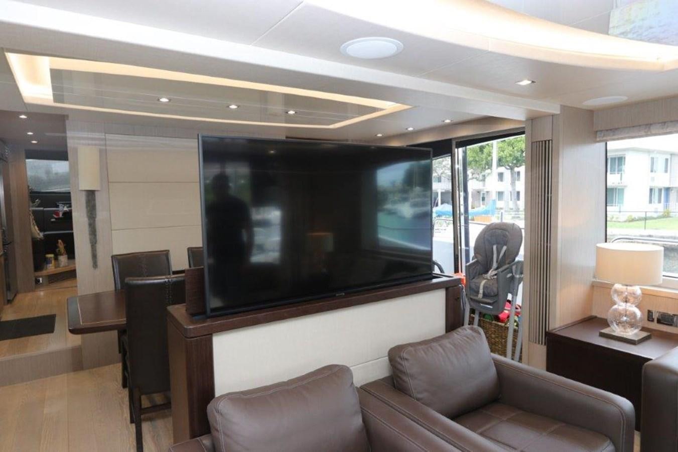 a living room with a large screen aboard AQUA VISTA Yacht for Sale