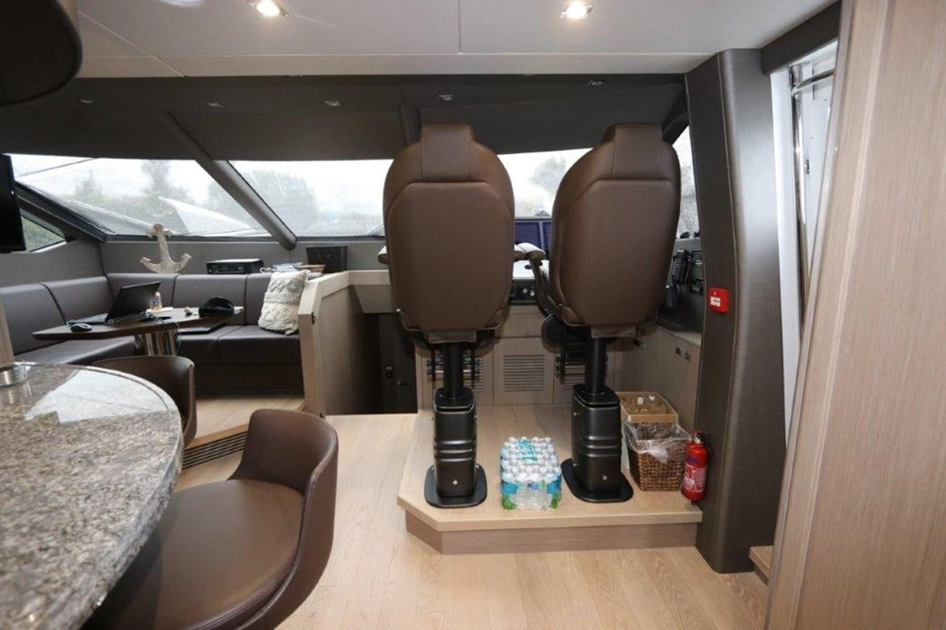 a room with a lamp and a table and chairs aboard AQUA VISTA Yacht for Sale