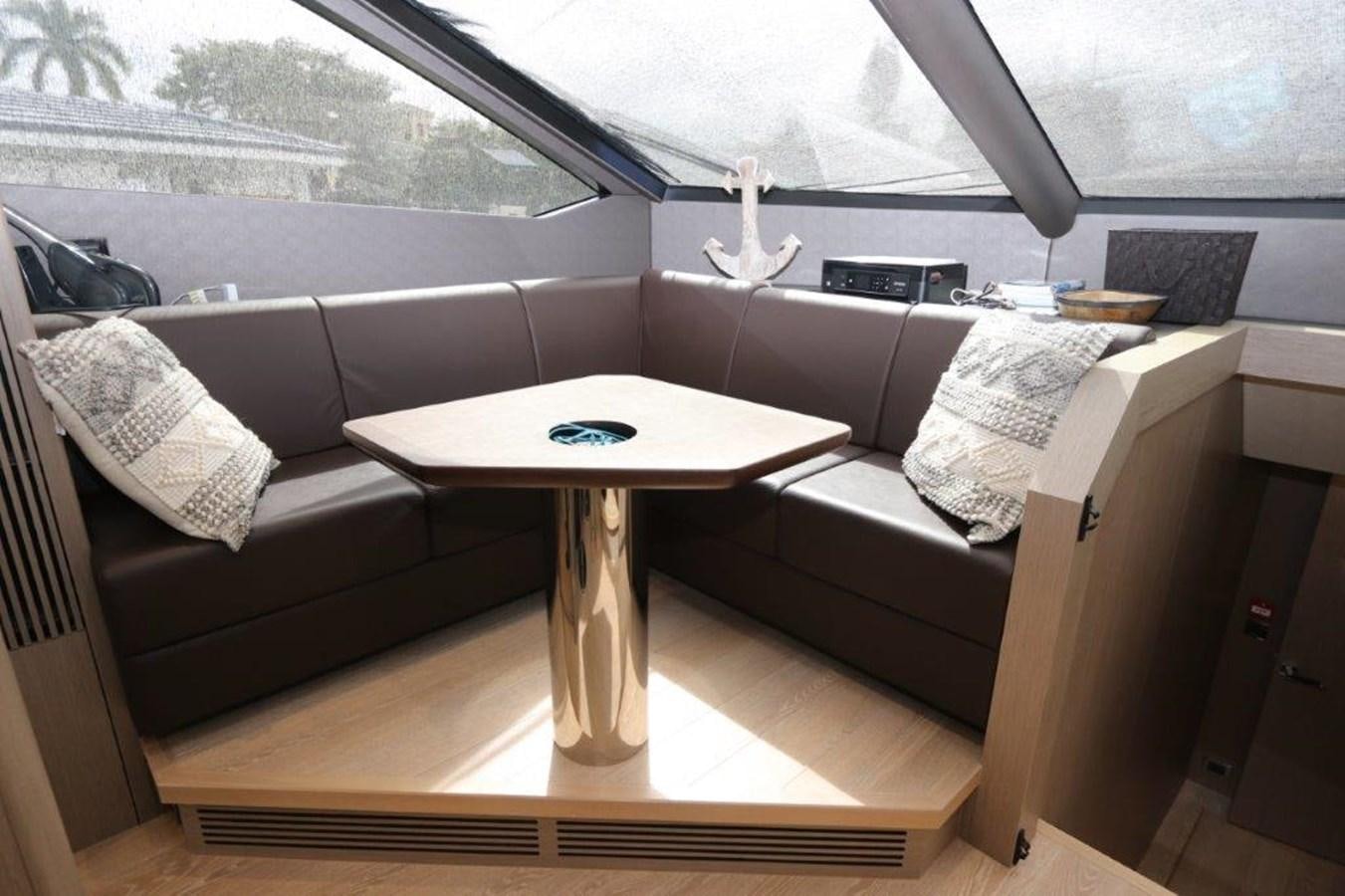 a living room with a couch and a coffee table aboard AQUA VISTA Yacht for Sale