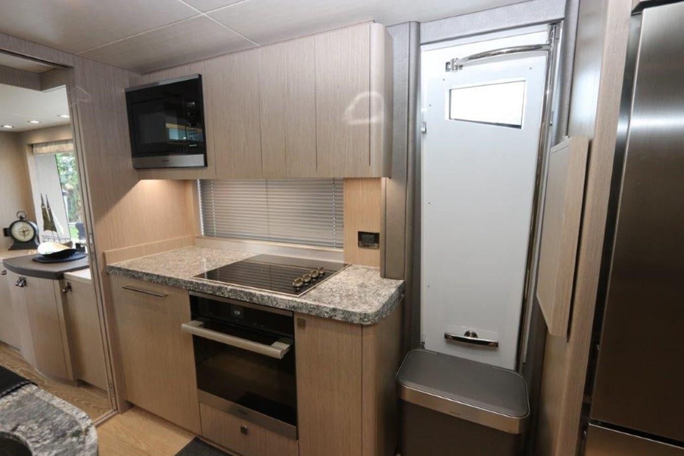 a kitchen with stainless steel appliances aboard AQUA VISTA Yacht for Sale