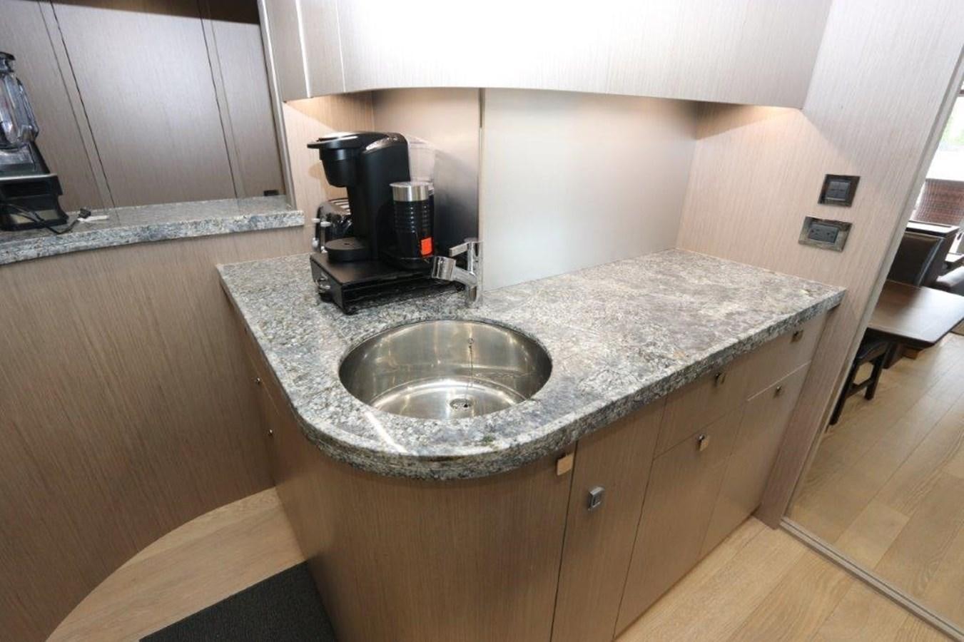 a kitchen counter with a sink and coffee maker aboard AQUA VISTA Yacht for Sale