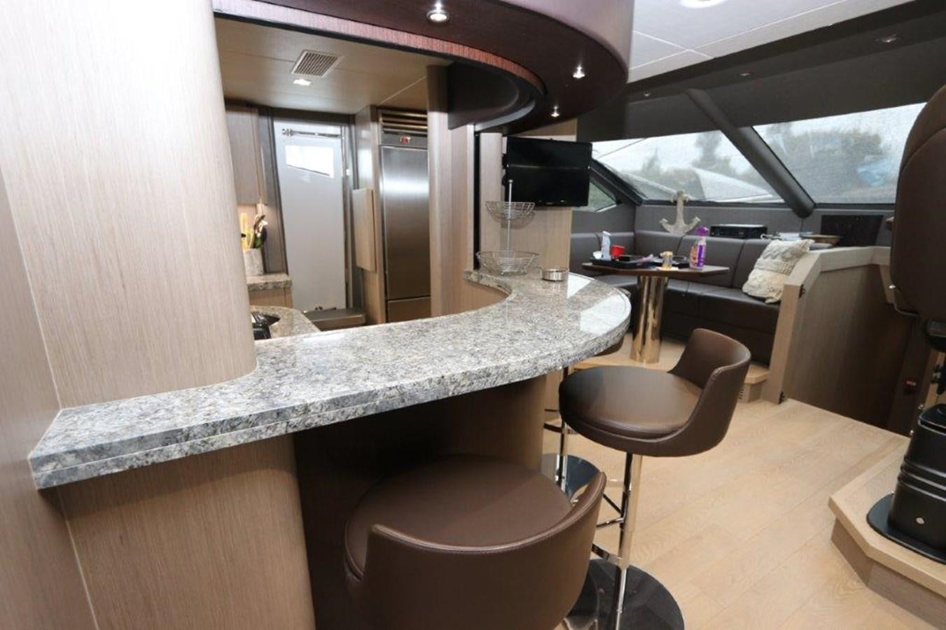 a counter with stools and a sink in a room with a large window aboard AQUA VISTA Yacht for Sale