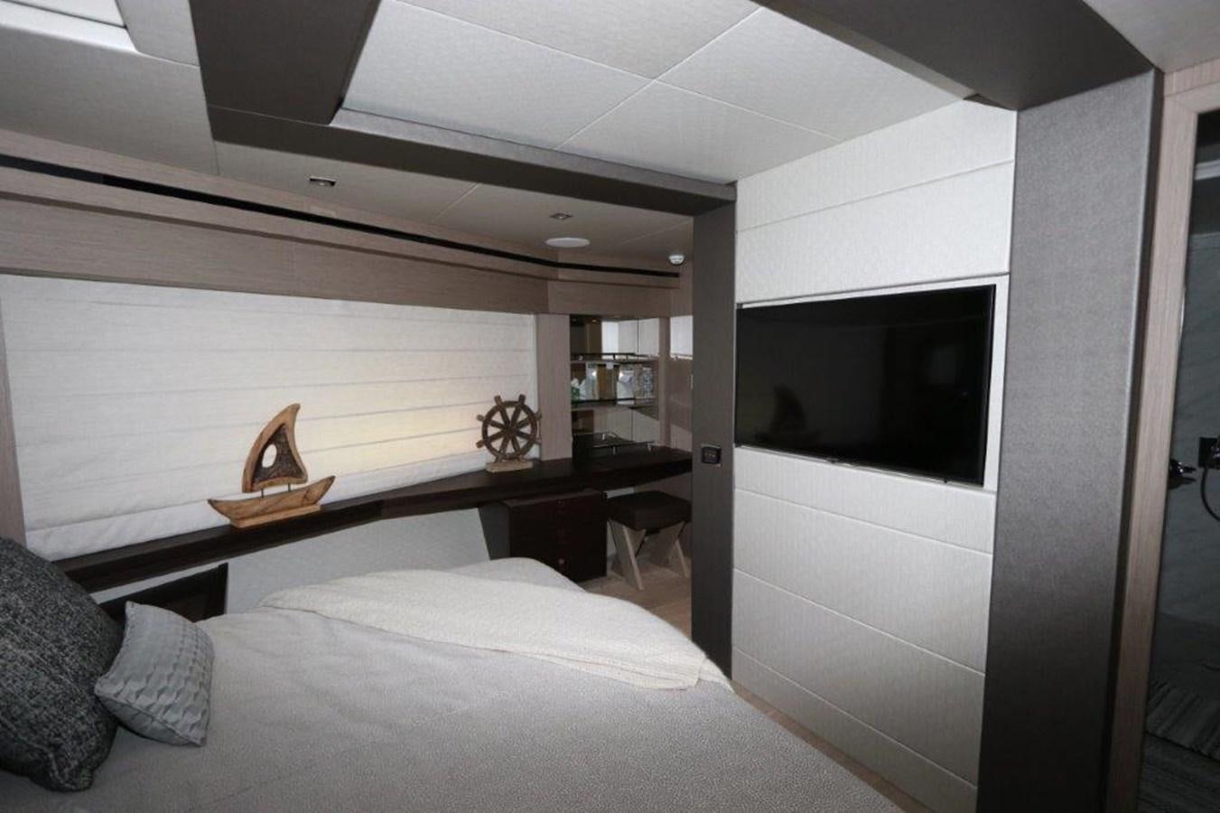 a bedroom with a bed and a television aboard AQUA VISTA Yacht for Sale