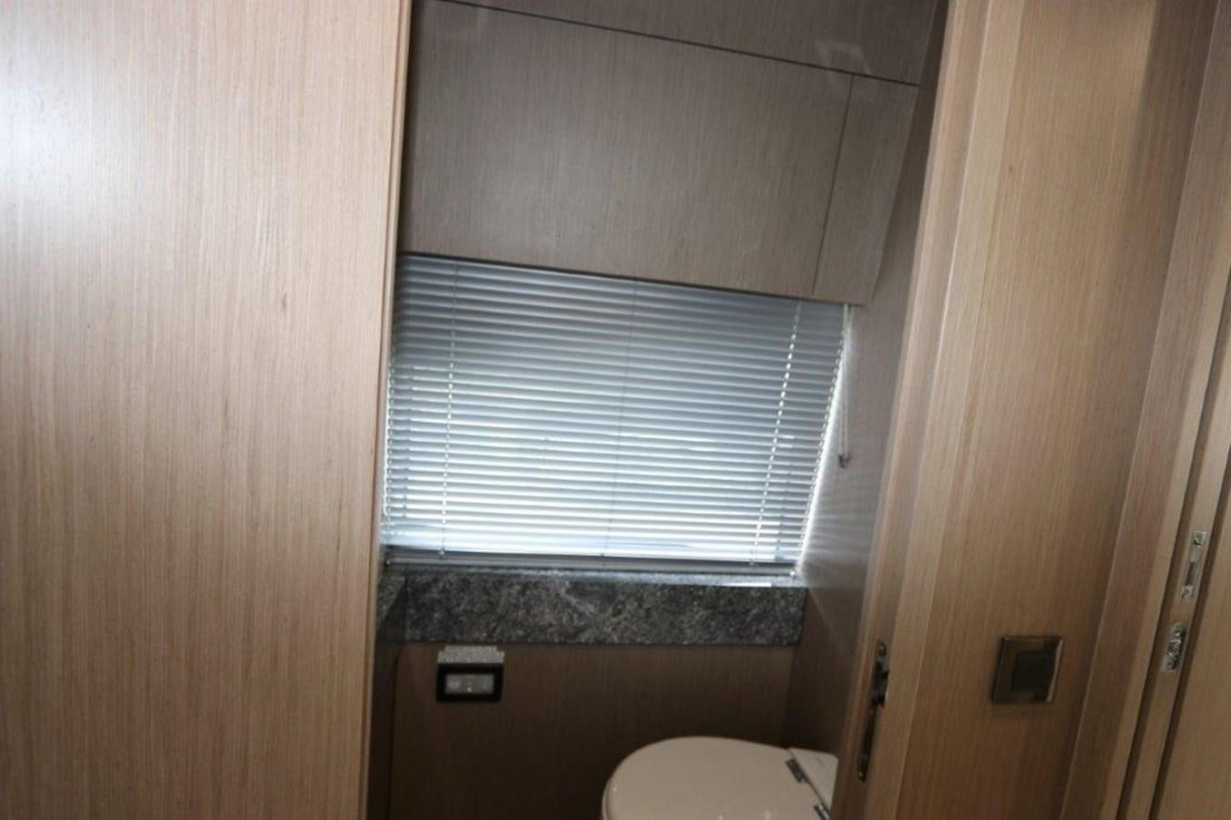 a small bathroom with a toilet aboard AQUA VISTA Yacht for Sale