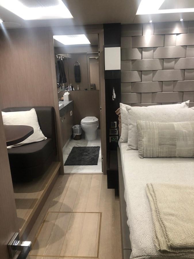a bathroom with a bed and a mirror aboard AQUA VISTA Yacht for Sale