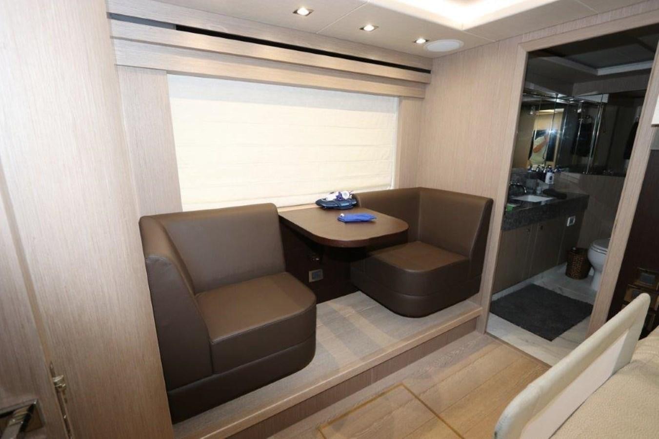 a living room with a table and chairs aboard AQUA VISTA Yacht for Sale