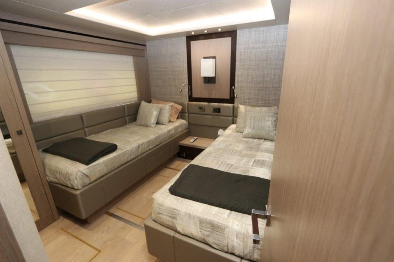 a room with a bed and a mirror aboard AQUA VISTA Yacht for Sale