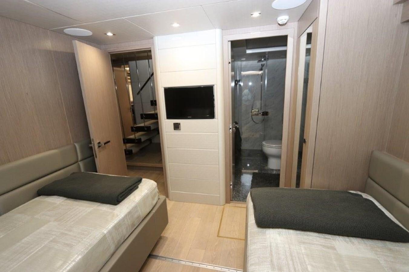 a hotel room with a bed and tv aboard AQUA VISTA Yacht for Sale