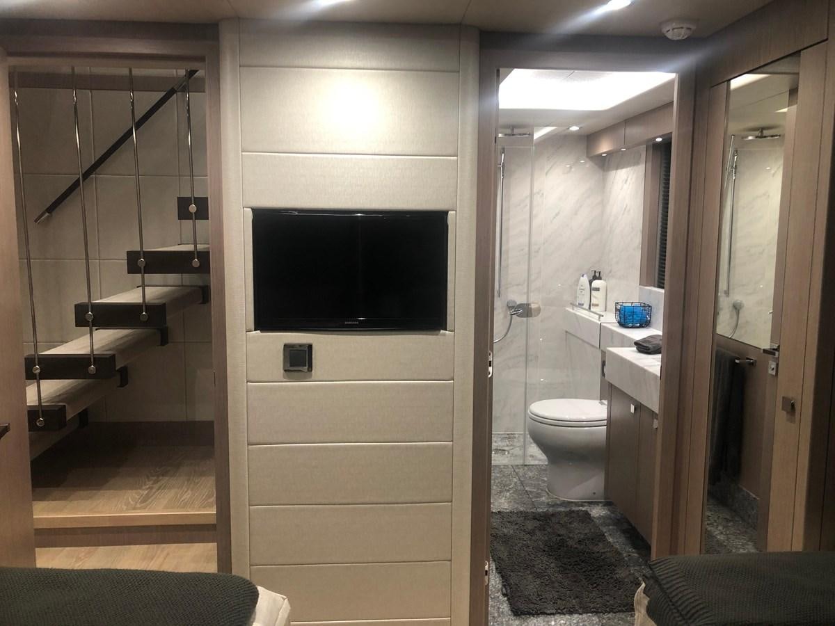 a bathroom with a toilet and a television aboard AQUA VISTA Yacht for Sale
