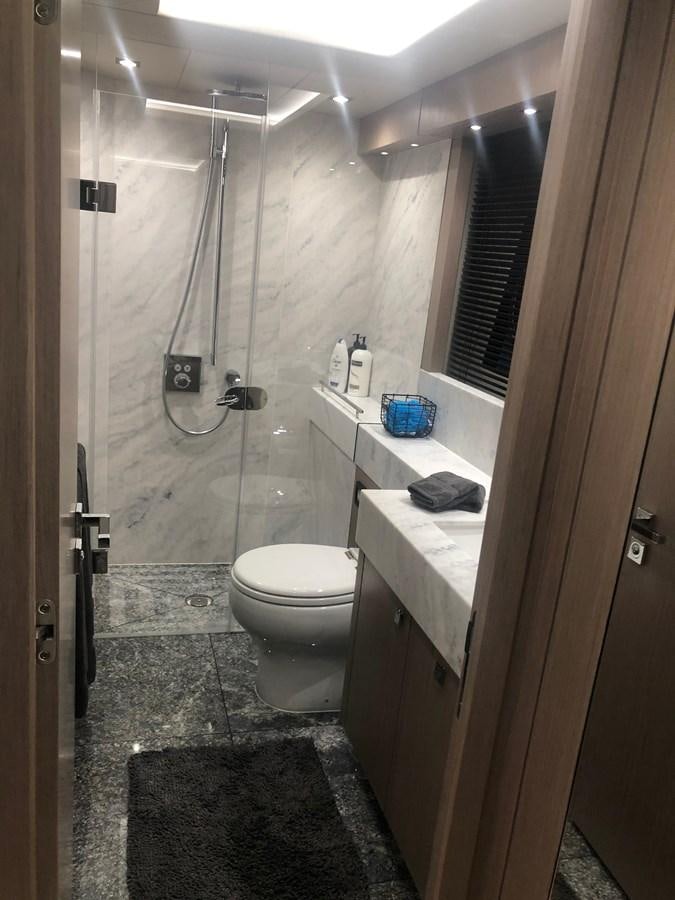 a bathroom with a toilet and sink aboard AQUA VISTA Yacht for Sale