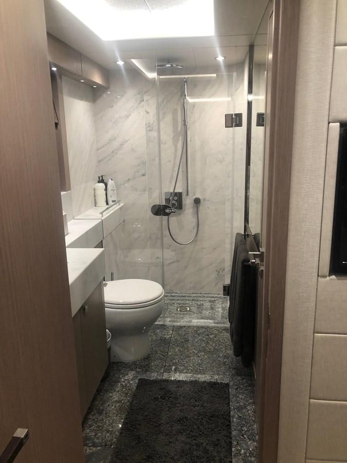 a bathroom with a toilet and sink aboard AQUA VISTA Yacht for Sale