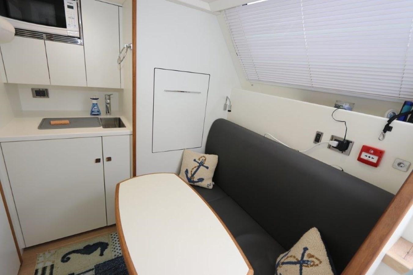 a black couch in a room aboard AQUA VISTA Yacht for Sale