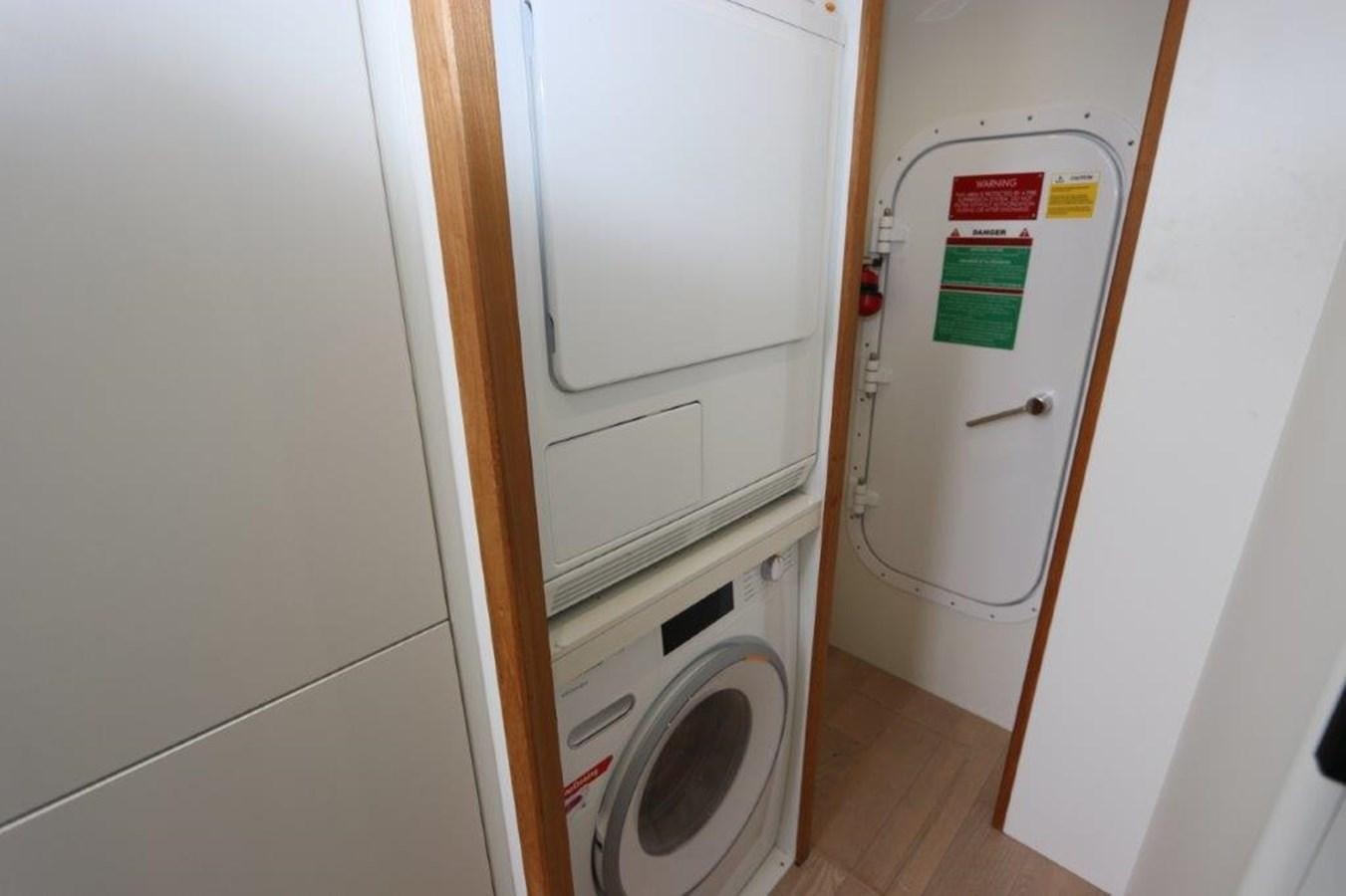 a closet with a washing machine aboard AQUA VISTA Yacht for Sale
