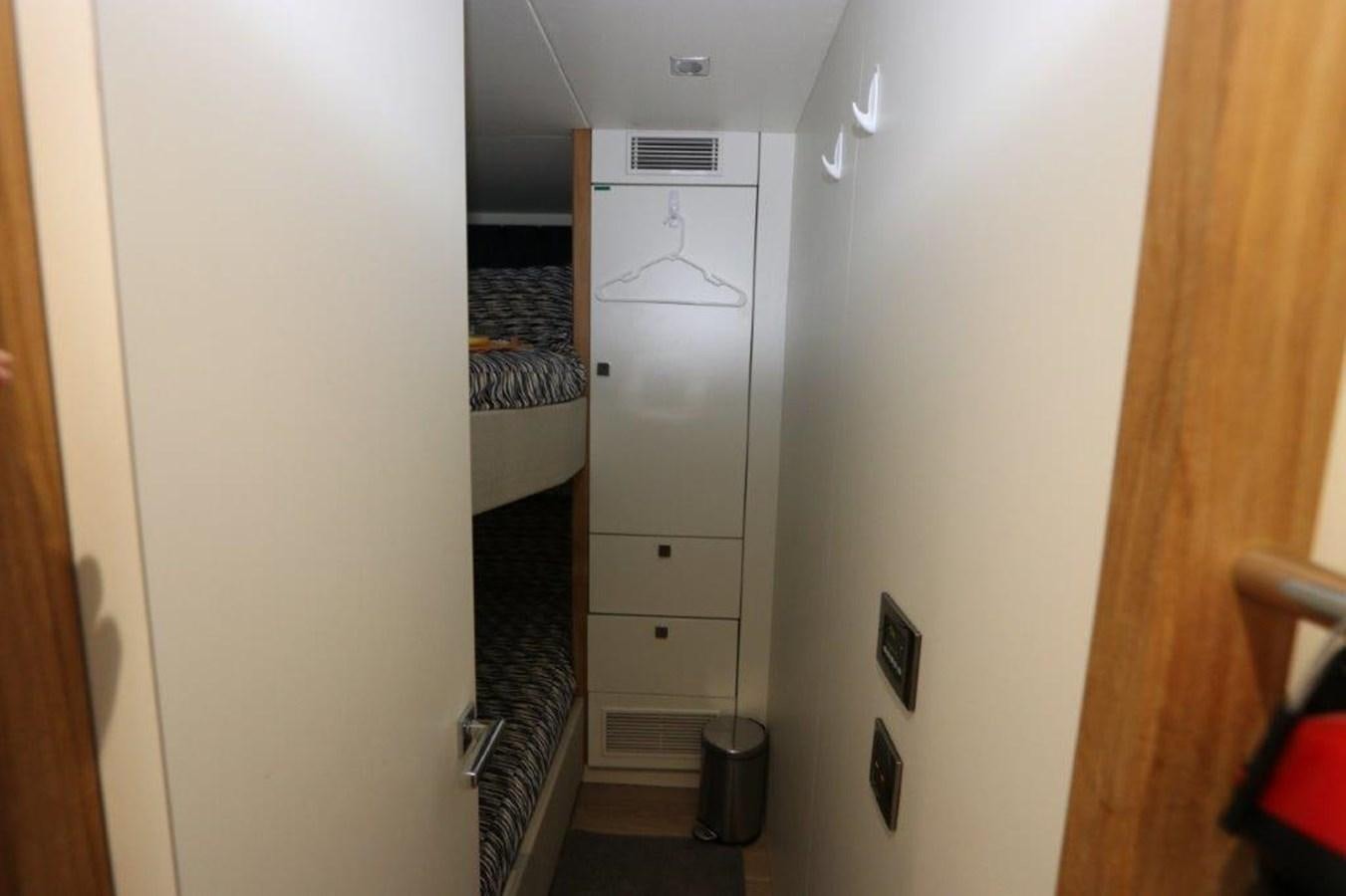 a closet with a bed and a trash can aboard AQUA VISTA Yacht for Sale