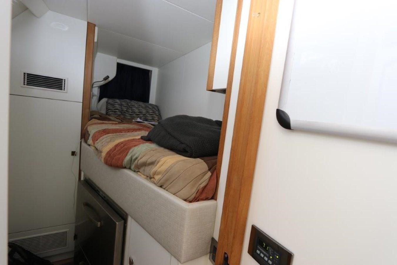 a small bedroom with a bed aboard AQUA VISTA Yacht for Sale