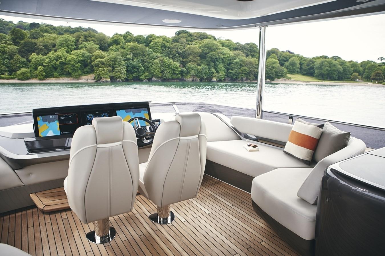 a room with a view of a lake and a laptop aboard PRINCESS Y85/504 Yacht for Sale