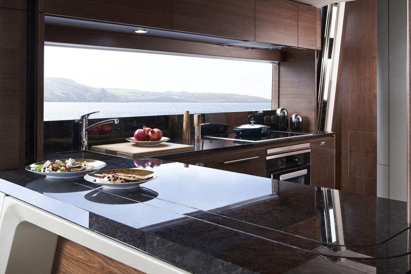 a kitchen with a large window aboard PRINCESS Y85/504 Yacht for Sale