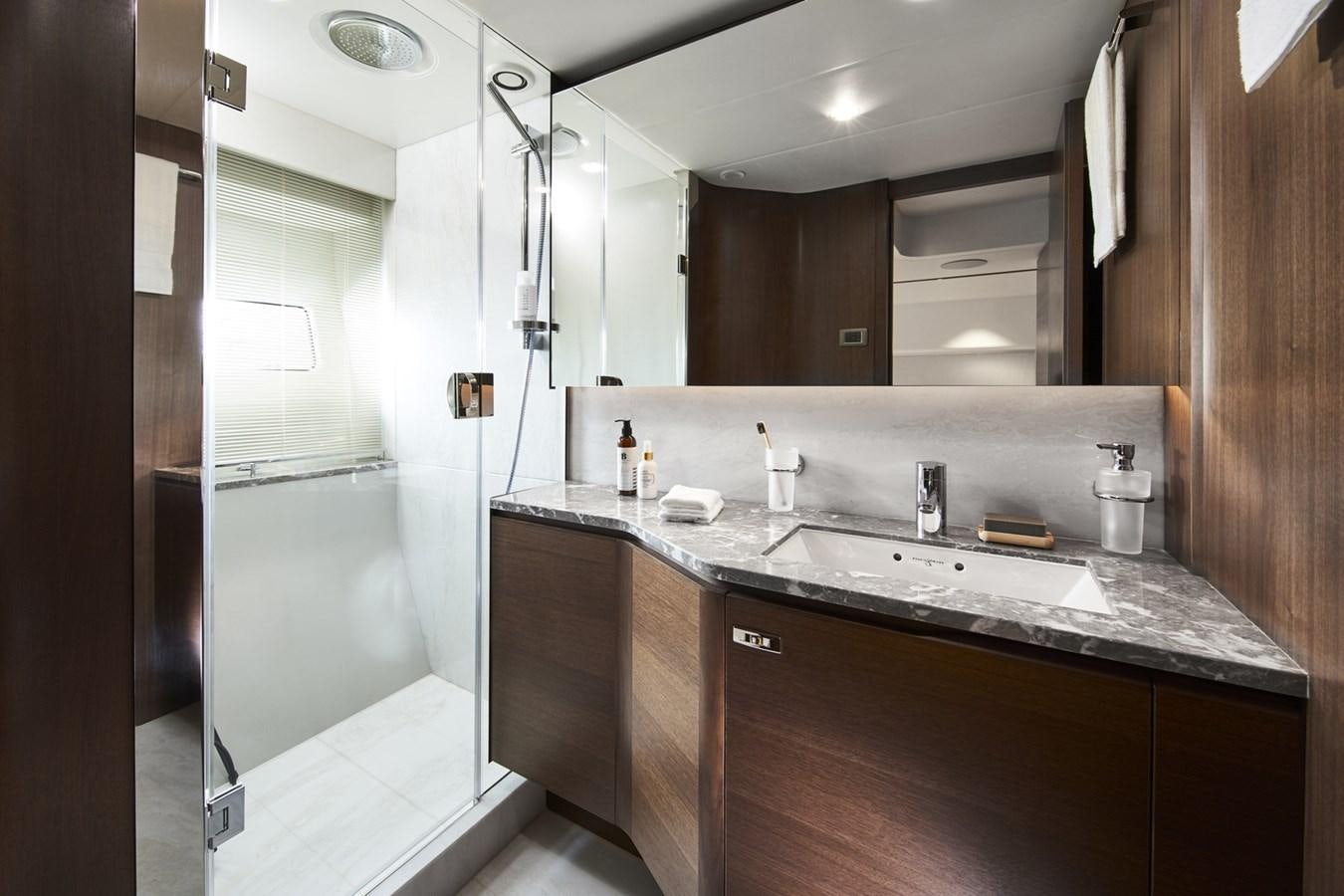 a bathroom with a sink and a mirror aboard PRINCESS Y85/504 Yacht for Sale