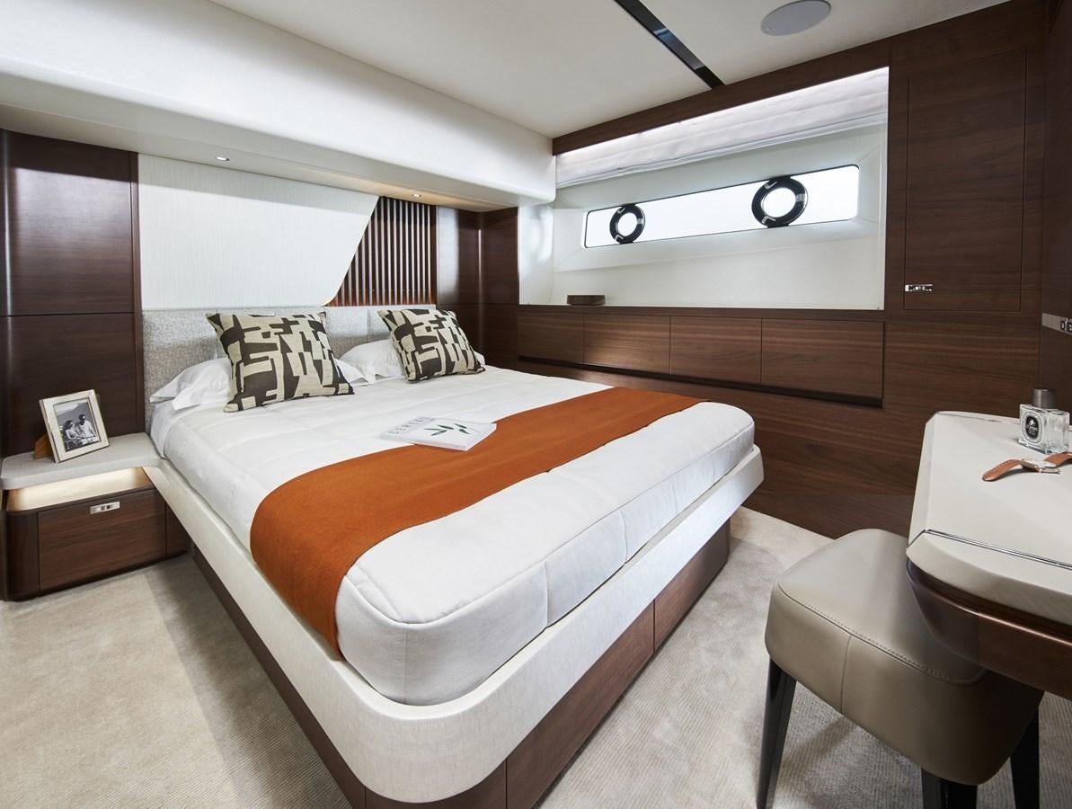 a room with a bed and a chair aboard PRINCESS Y85/504 Yacht for Sale