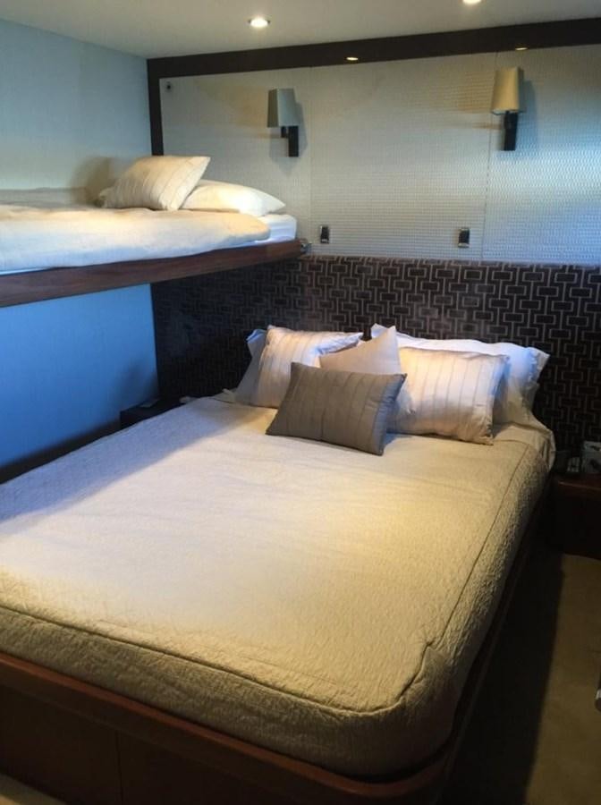 a bed with blue and white sheets aboard PRINCESS 85MY Yacht for Sale
