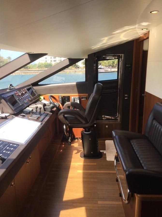 a room with a desk and chairs aboard PRINCESS 85MY Yacht for Sale
