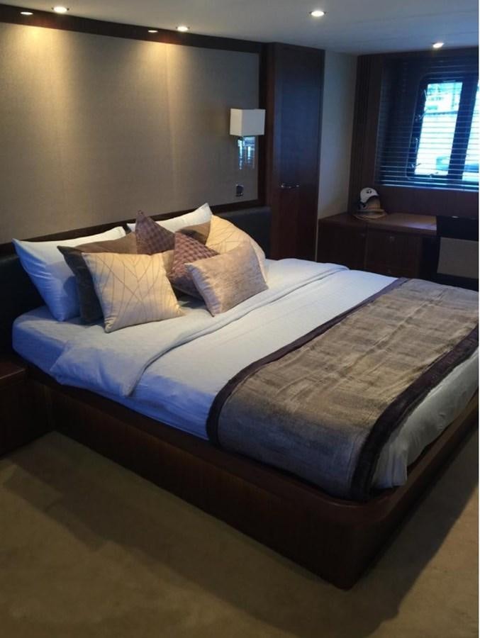 a bed with a blue comforter aboard PRINCESS 85MY Yacht for Sale