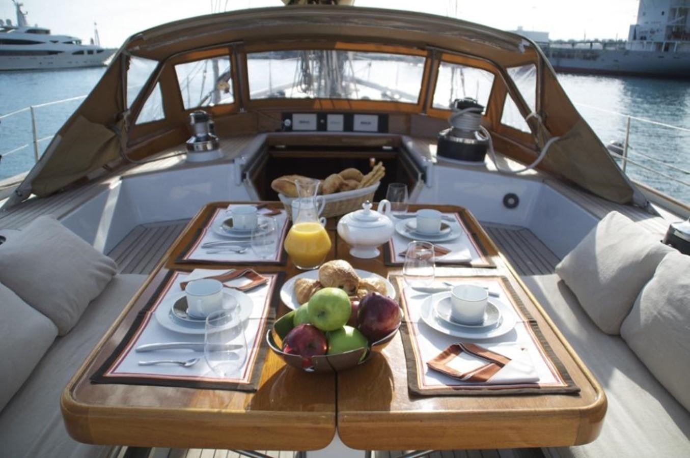 a boat with a table and food on it aboard VOLADOR Yacht for Sale