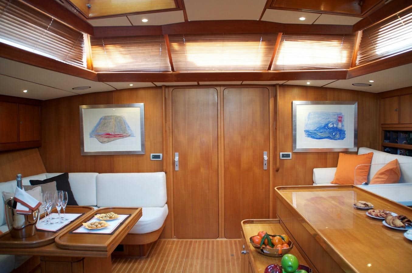 a room with a table and chairs aboard VOLADOR Yacht for Sale