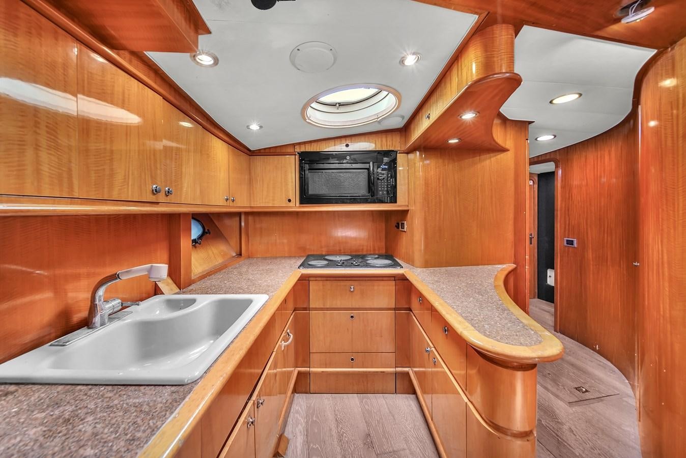 a kitchen with wooden cabinets aboard ZOOOM Yacht for Sale
