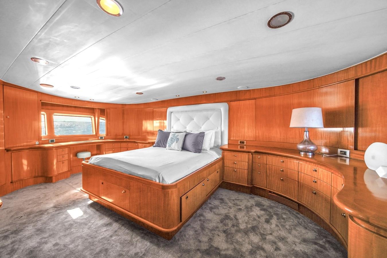 a bedroom with a bed and a desk aboard ZOOOM Yacht for Sale