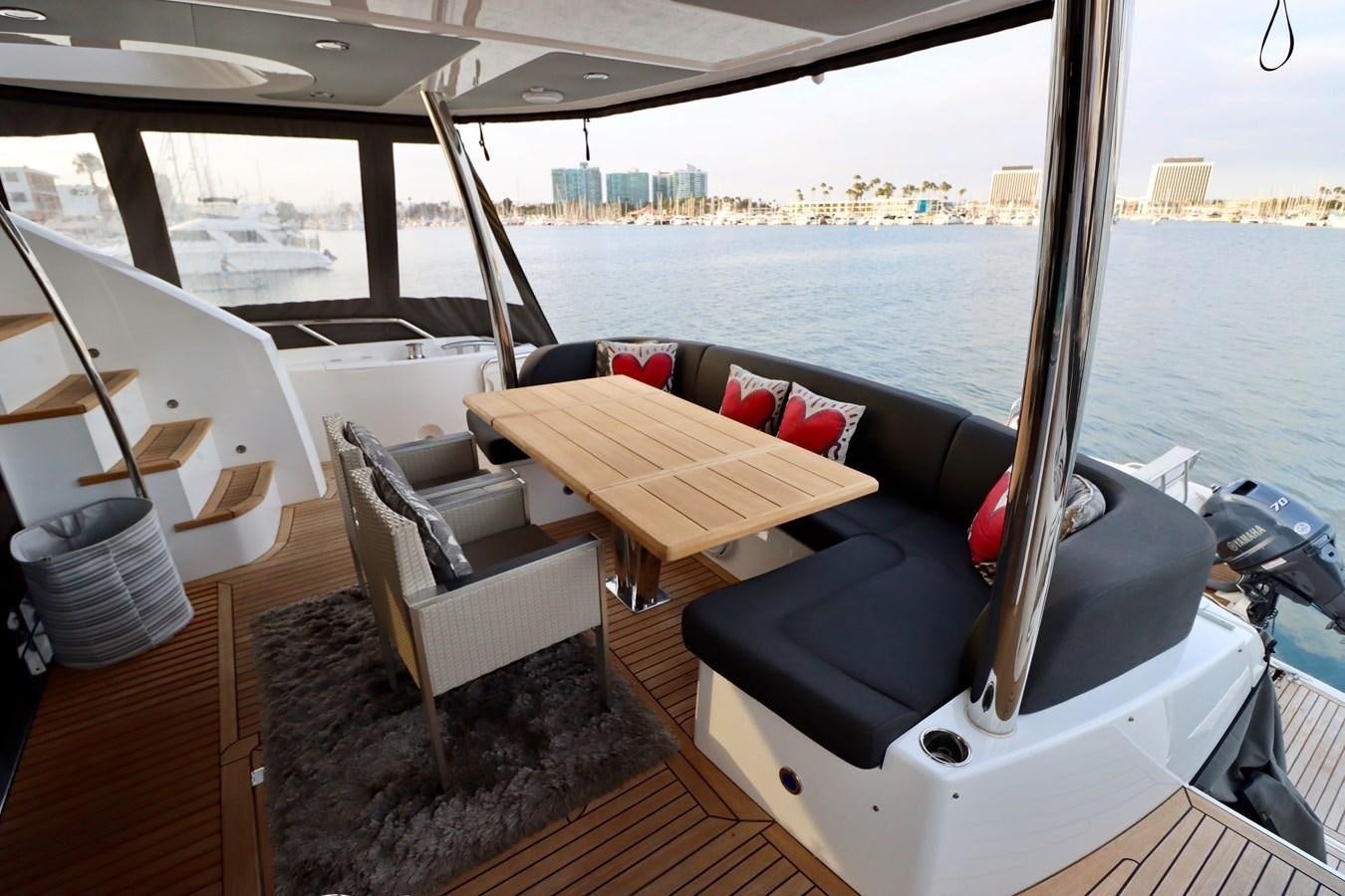 a room with a couch and a table and chairs aboard MOJO RISIN Yacht for Sale