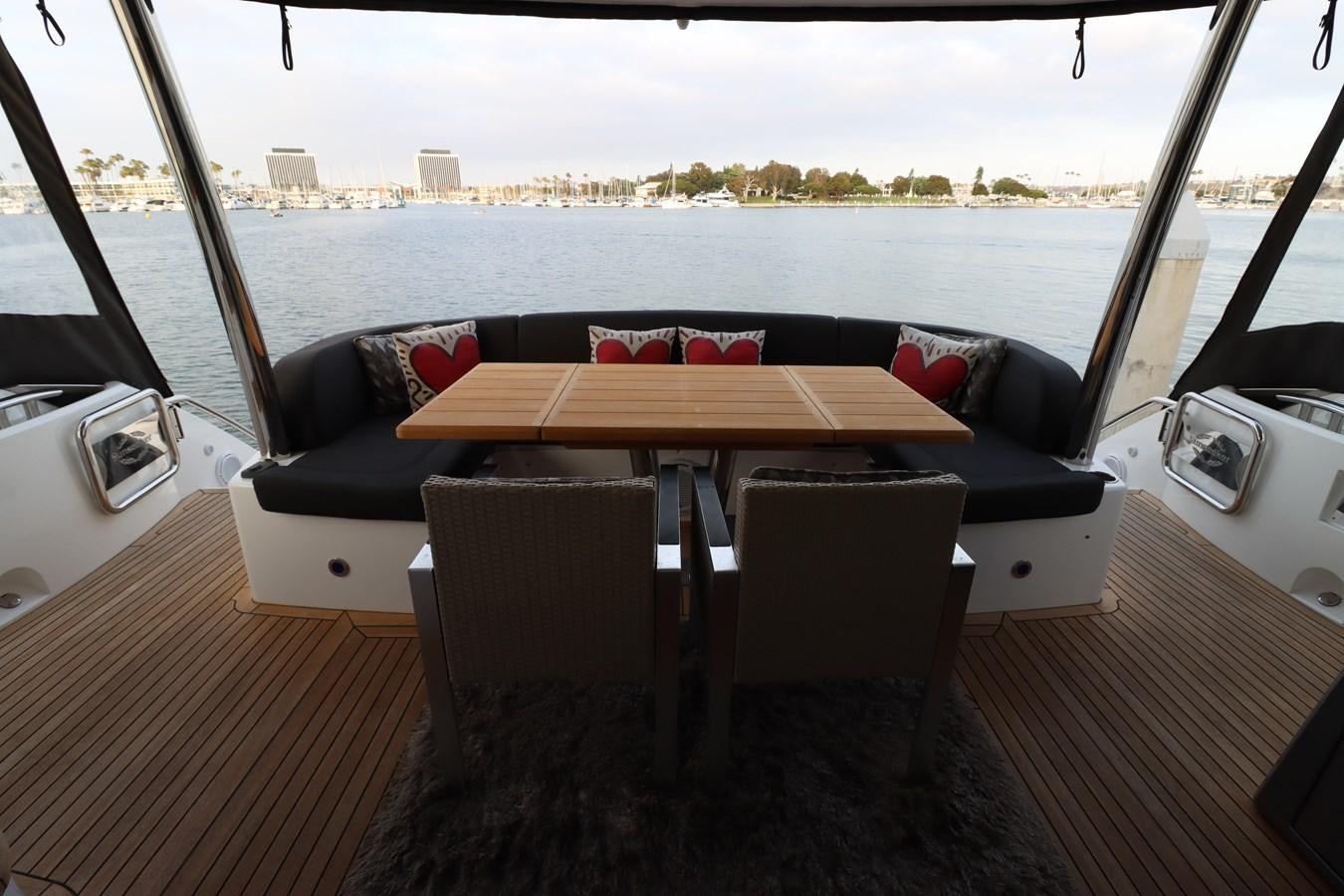 a table and chairs on a boat aboard MOJO RISIN Yacht for Sale