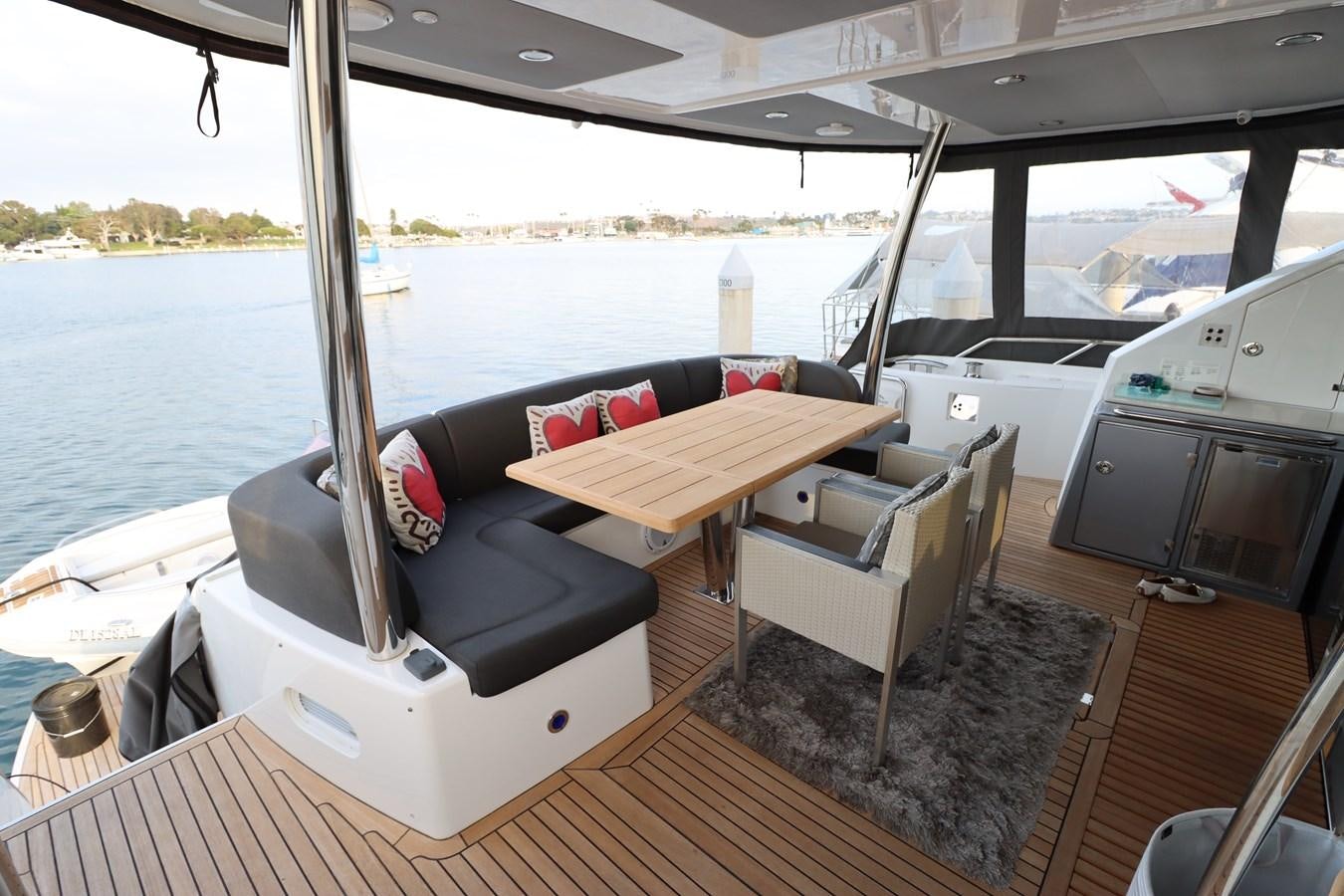 a boat with a table and chairs aboard MOJO RISIN Yacht for Sale