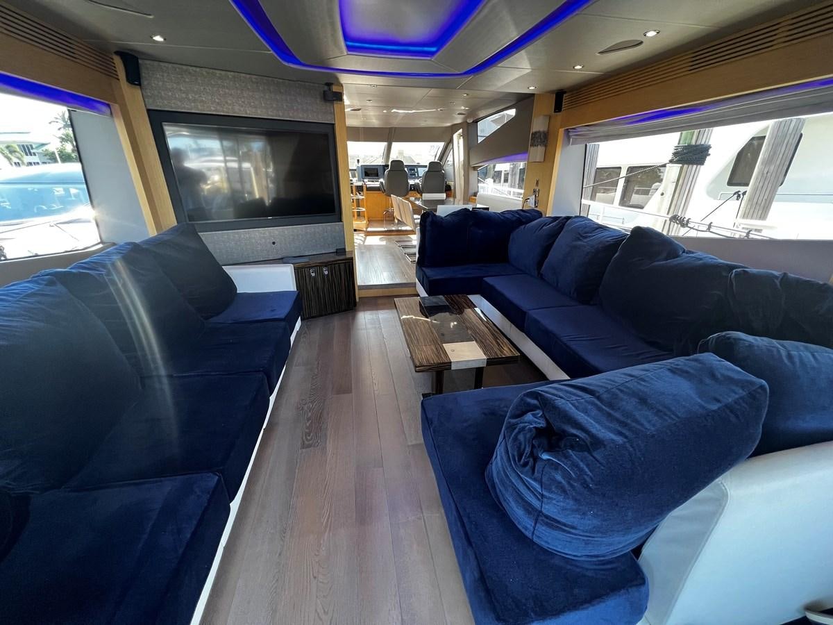 a room with couches and a television aboard MOJO RISIN Yacht for Sale