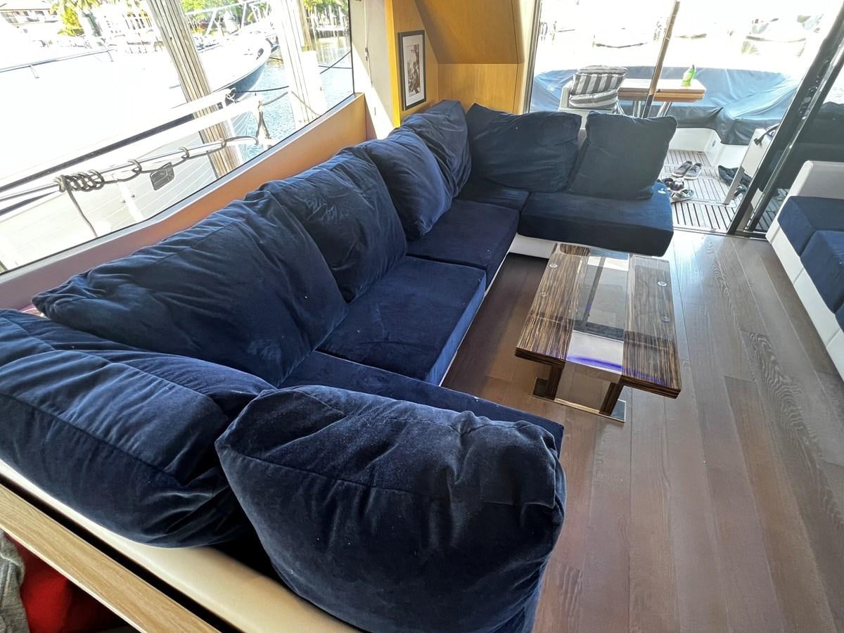 a couch with a table and chairs aboard MOJO RISIN Yacht for Sale