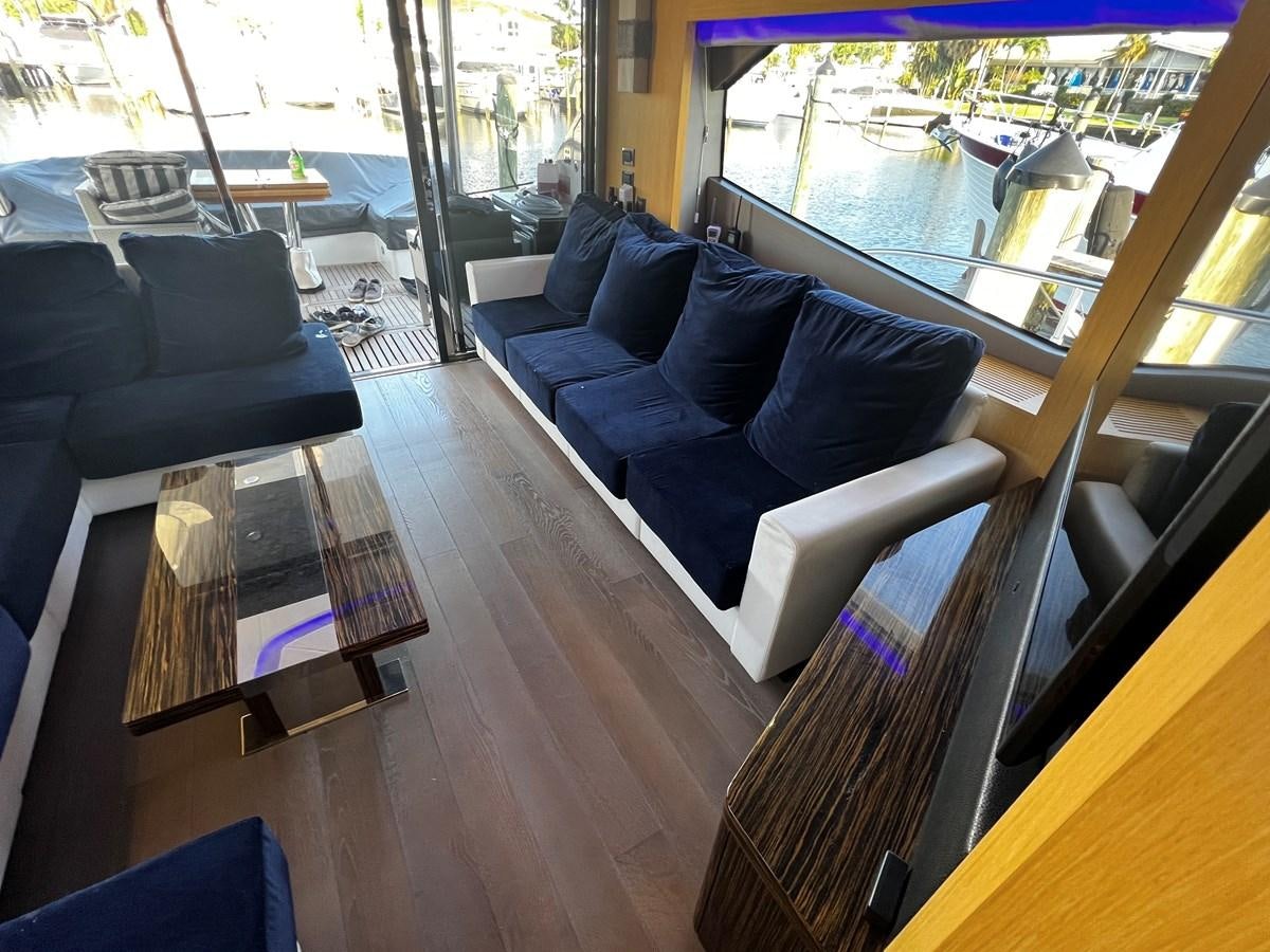 a living room with a wood floor aboard MOJO RISIN Yacht for Sale