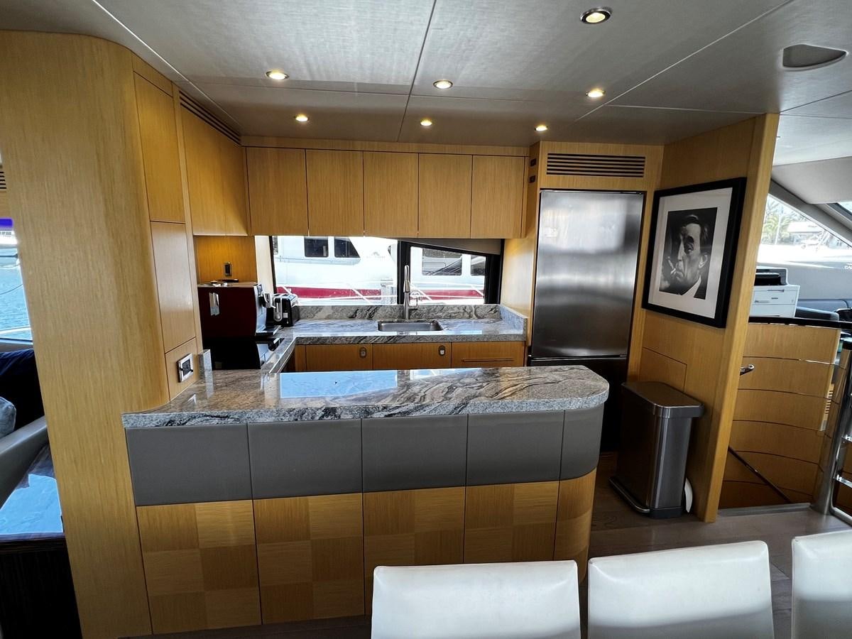 a kitchen with a large island aboard MOJO RISIN Yacht for Sale
