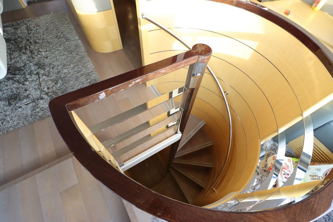 a wooden chair with a seat aboard MOJO RISIN Yacht for Sale