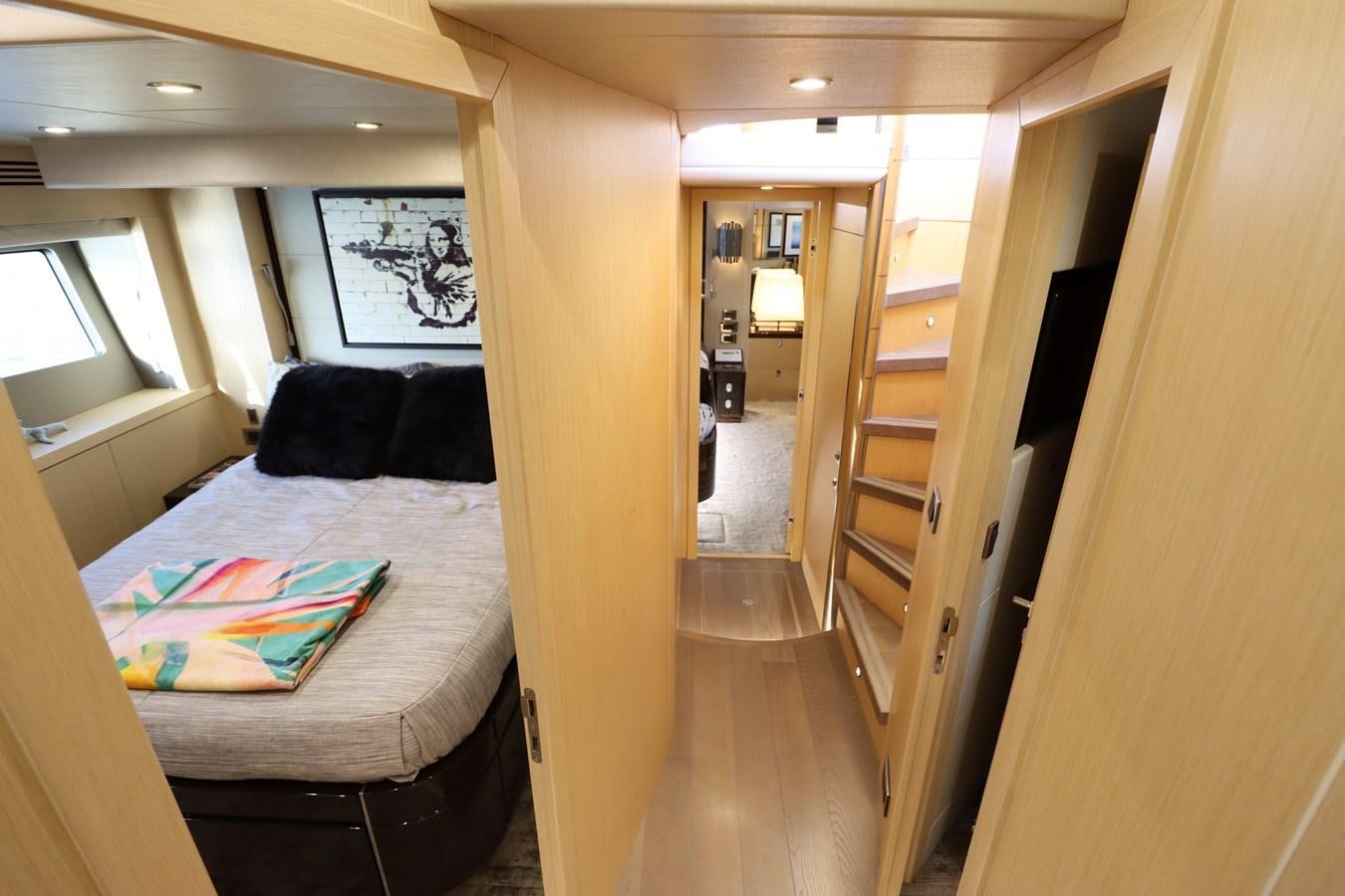 a bedroom with a bed and a ladder aboard MOJO RISIN Yacht for Sale