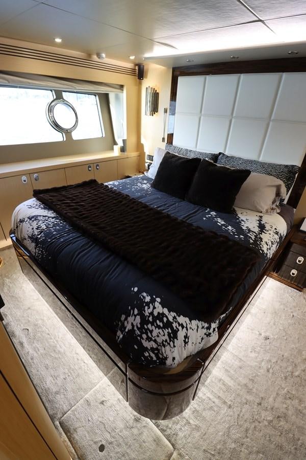a bed with black and white sheets aboard MOJO RISIN Yacht for Sale