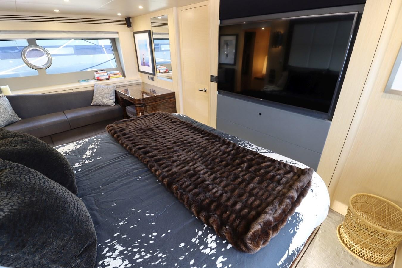 a living room with a couch and a fireplace aboard MOJO RISIN Yacht for Sale