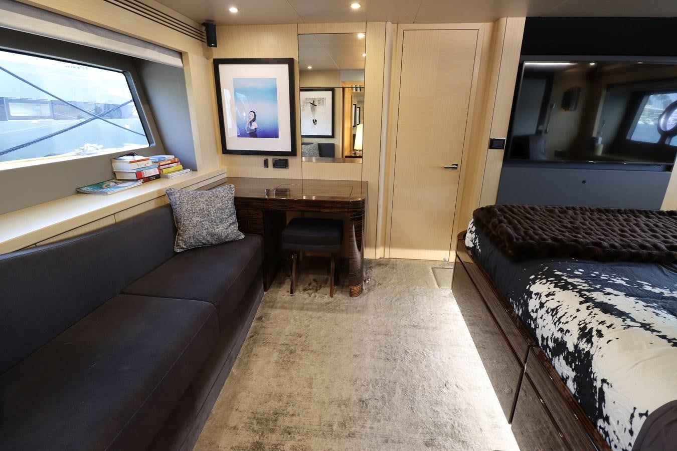 a bedroom with a bed and a desk aboard MOJO RISIN Yacht for Sale